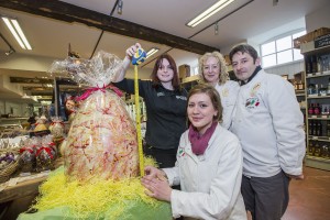 Giant Easter egg from Baravelli's at Bodnant Farm Food. Measuring the huge chocoalte delight, Hayley Roberts and Charlie Wilson form Garavelli's watched by Emma and Mark Baravelli.