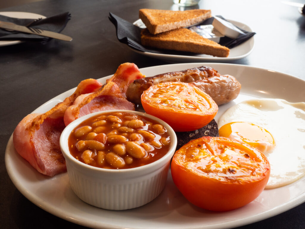 cooked breafast, eggs, beans, bacon, sausages and tomatos