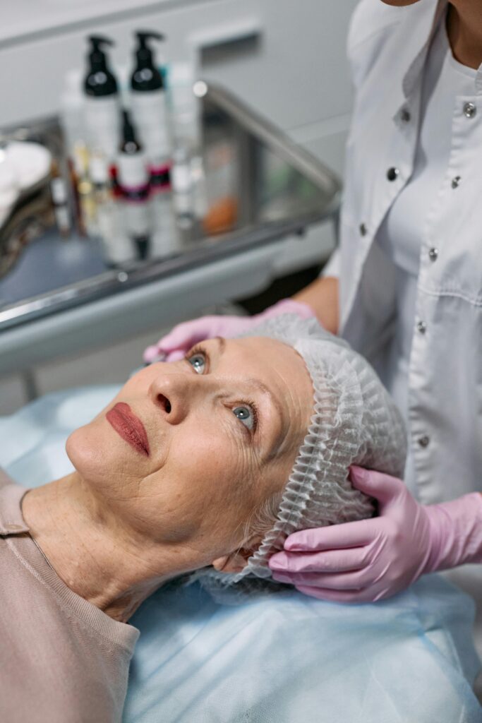 aesthetics patient reclining with a hat to save hair